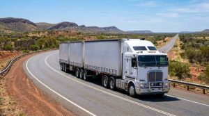 Heavy-duty commercial truck driving on an open highway representing battery selection guide